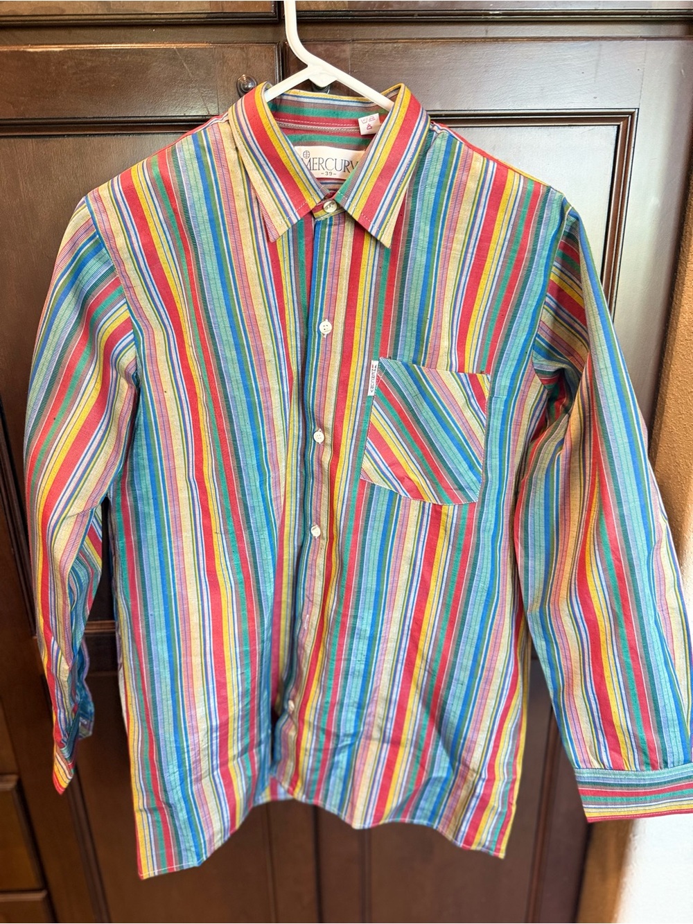 This is a vibrant vintage Mercury long-sleeve button-up shirt featuring an eye-c